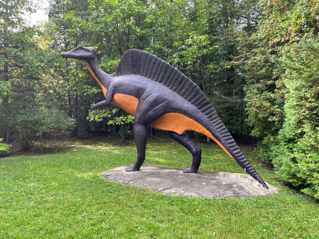 A striking black and orange Spinosaurus statue